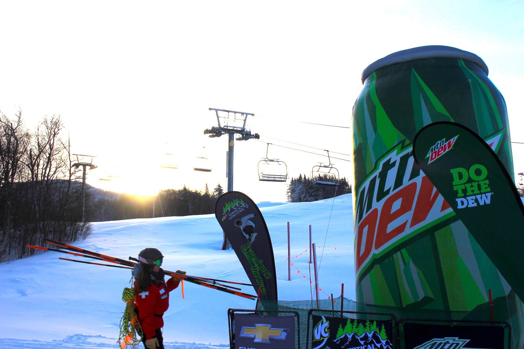 Patrol walks to the lift next to inflatable can of soda and some branded flags