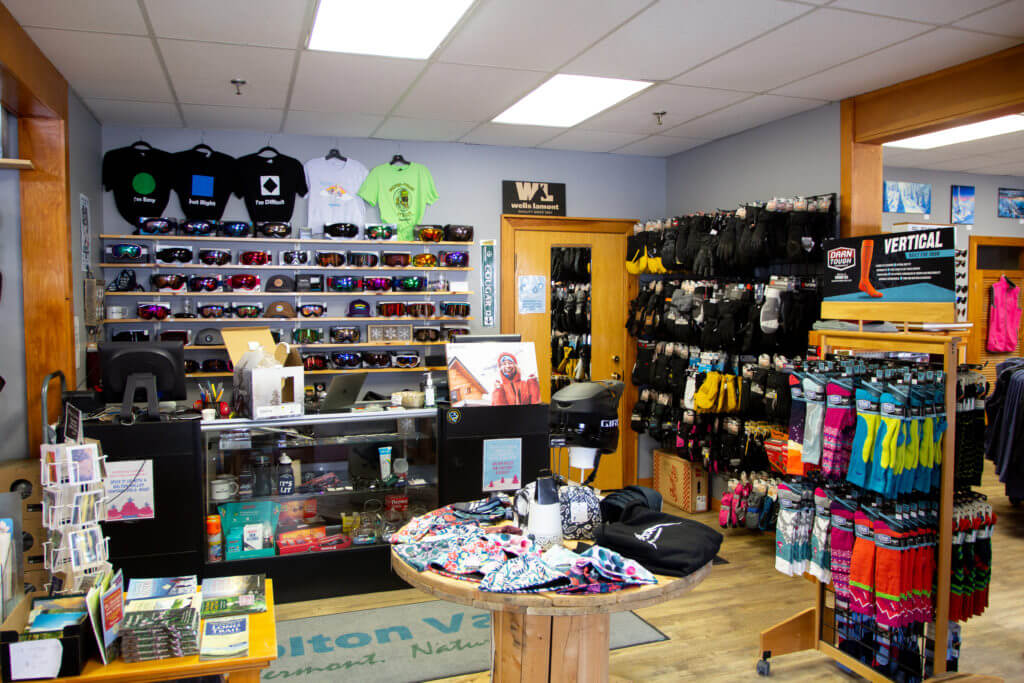 Inside of Ski Shop with displays of googles, t-shirts, mittens, gloves, and socks