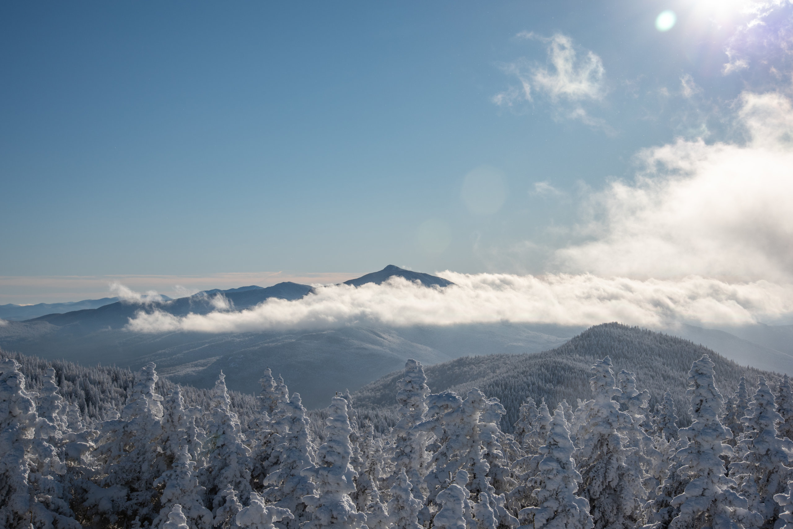 Beautiful View From the Summit of Bolton Valley Ski Resort Looking South to Camel's Hump Poking Out Through The Clouds