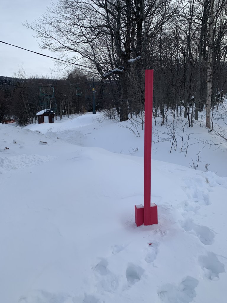 The pink snow stake sits coated with a fresh layer of snow from the past storm.