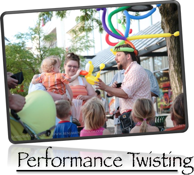 Dux Commands a crowd in downtown Burlington with his performance balloon twisting