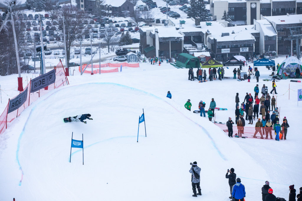 A Snowboarder Carves a Turn into a Big Banked Slalom Berm