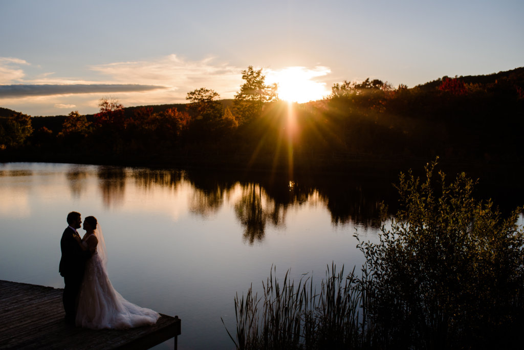 Newlywes Enjoy the Setting Sun from the Dock Overlooking the Pond