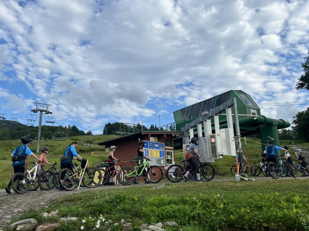 A Group of Riders Prepare to Load the Lift with Mountain Bikes