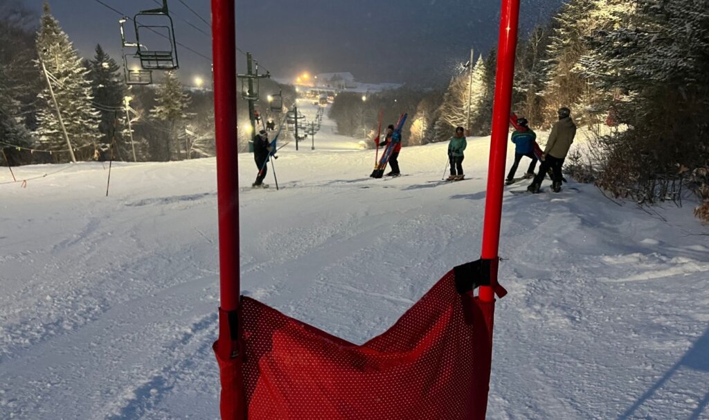 Some skiers chat on the slalom course