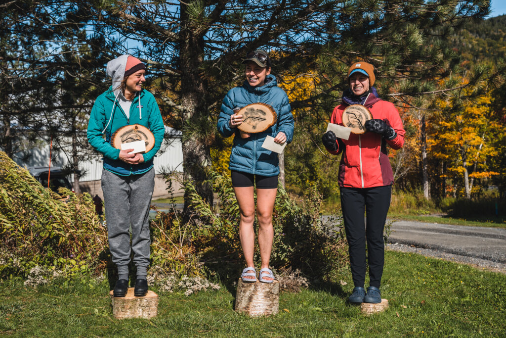 Three Women Stand on the Podium After Completing a Race