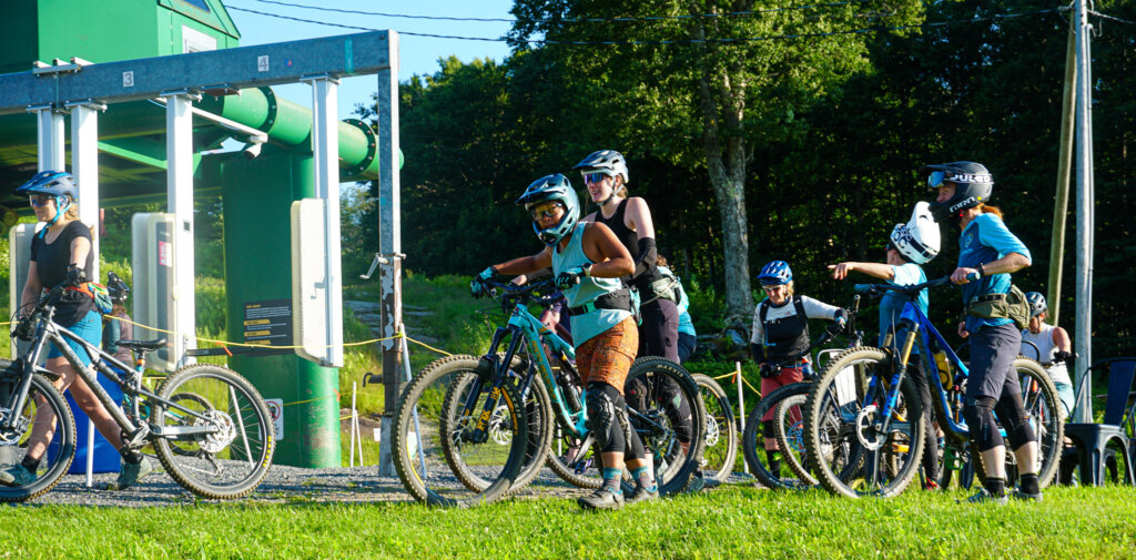 Group of women mountain bikers line up to load the bike lift