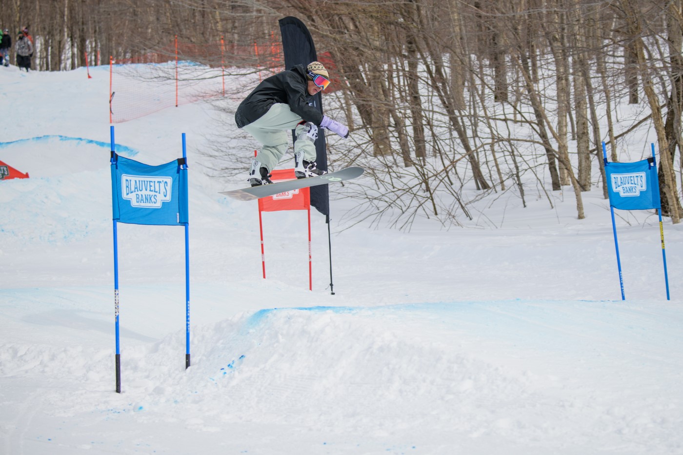 A snowboarder gets air during the 2023 Blauvelt's Banks at Bolton Valley