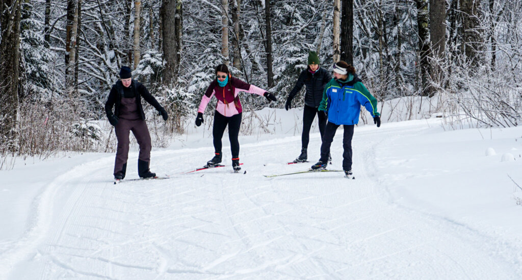 Group of women learn how to skate ski on the Nordic Ski trails