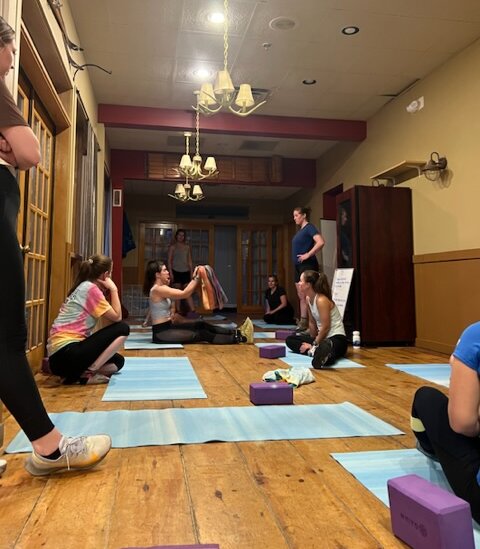 Group of women exercising on yoga mats inside