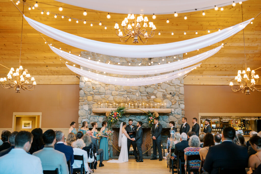 The Ponds interior with a bride and groom mid ceremony in front of guests